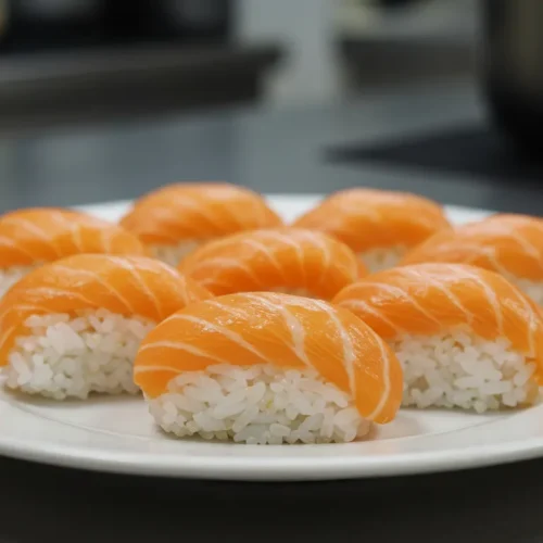 Low sodium salmon and brown rice nigiri served on a kitchen counter, showcasing fresh salmon and brown rice.