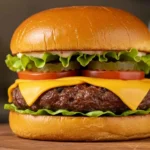 Juicy Wagyu beef burger with melted cheddar, lettuce, tomato, and pickles on a toasted brioche bun, served on a wooden board.