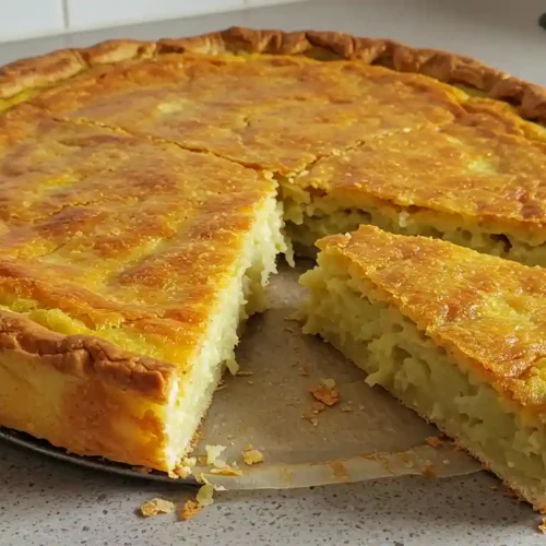 Golden-brown Passover potato pie fresh out of the oven, sliced to show tender interior.